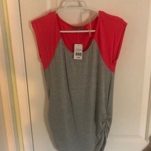 I’m selling a gray shirt with pinkish/red short sleeves.